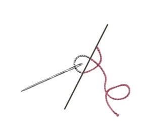 A needle and thread, half engraving and half color, split by a diagonal line.